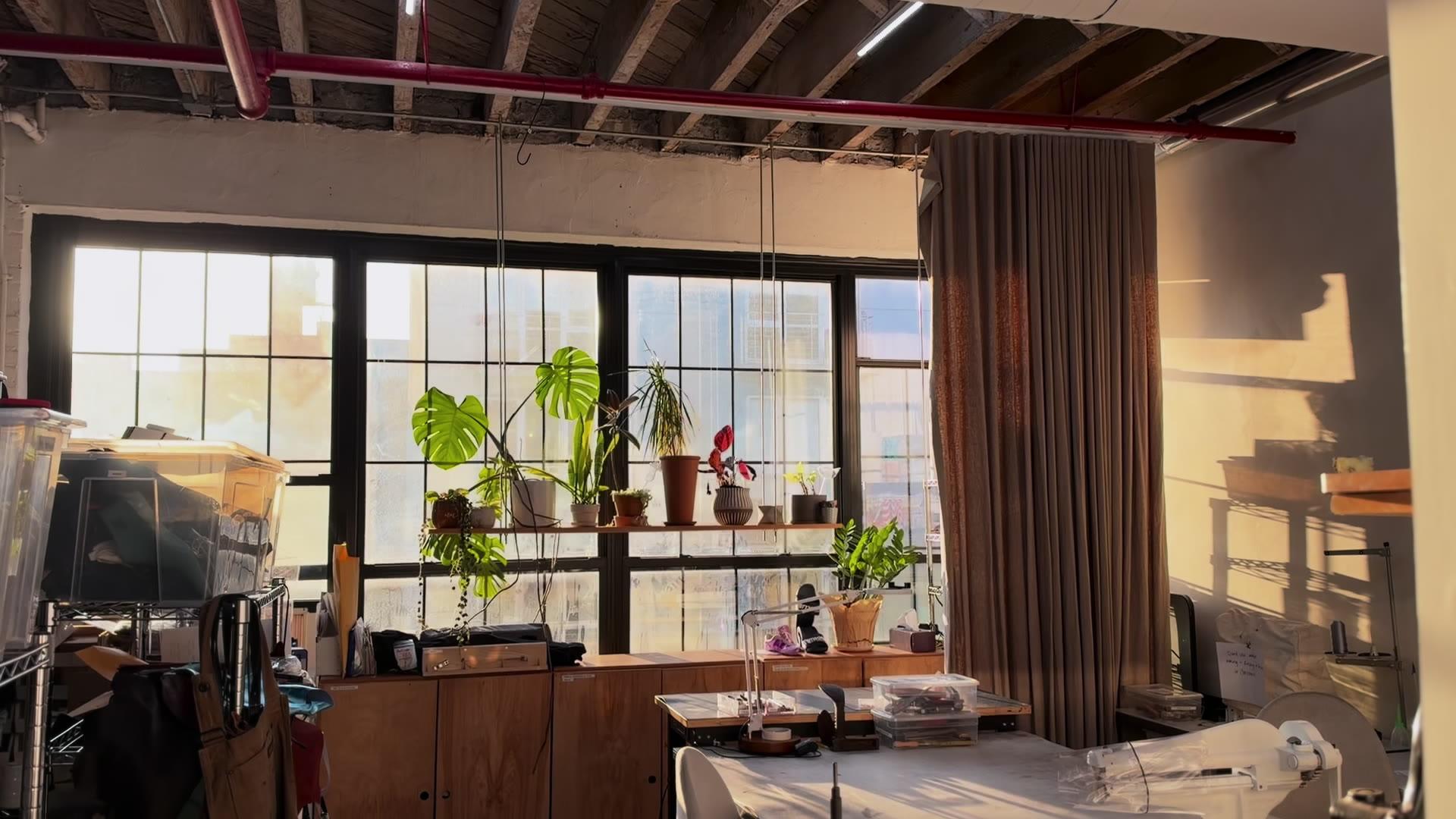 Inside the studio: the workroom, a post-bed sewing machine, shelves of lasts and racks of leather